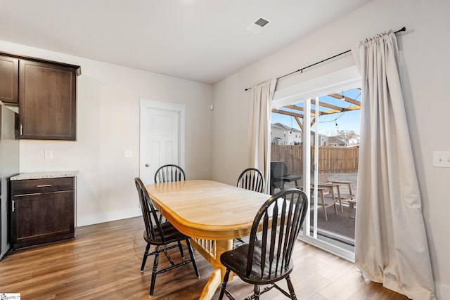 dining space with light hardwood / wood-style flooring