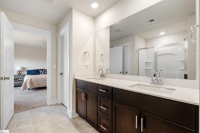 bathroom with vanity and a shower with door