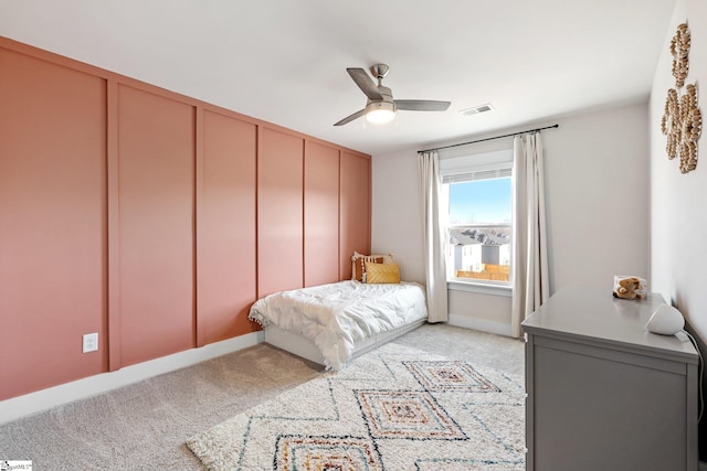 bedroom with light colored carpet, ceiling fan, and a closet