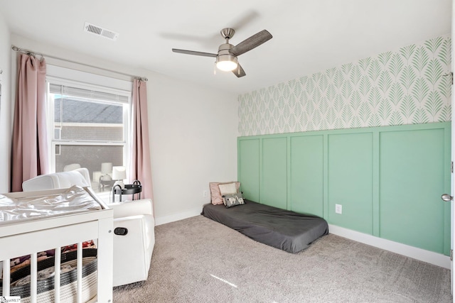 bedroom featuring light colored carpet and ceiling fan