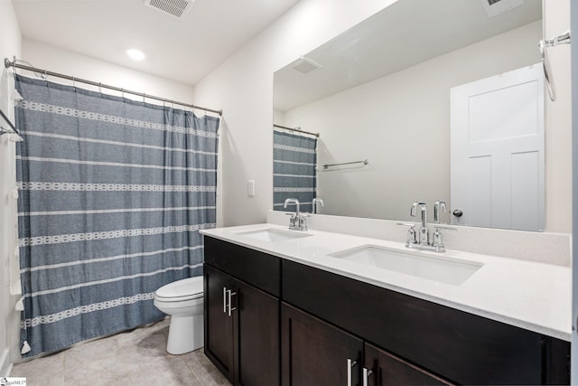 bathroom featuring a shower with curtain, vanity, tile patterned floors, and toilet