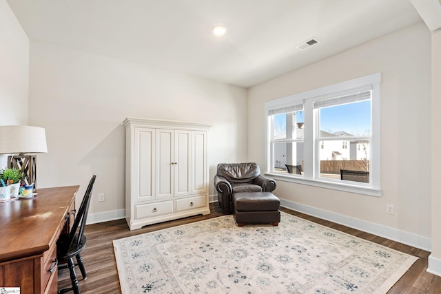 sitting room with dark hardwood / wood-style flooring