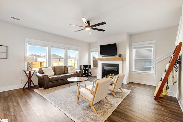 living room featuring dark hardwood / wood-style flooring and ceiling fan