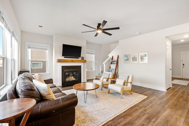 living room with hardwood / wood-style flooring and ceiling fan