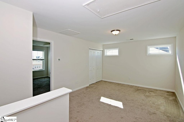 spare room featuring light colored carpet