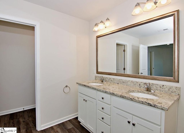 bathroom with hardwood / wood-style flooring and vanity