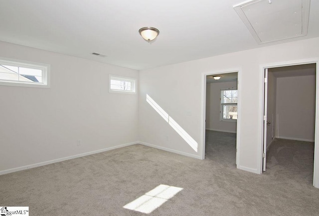 basement with a healthy amount of sunlight and light carpet