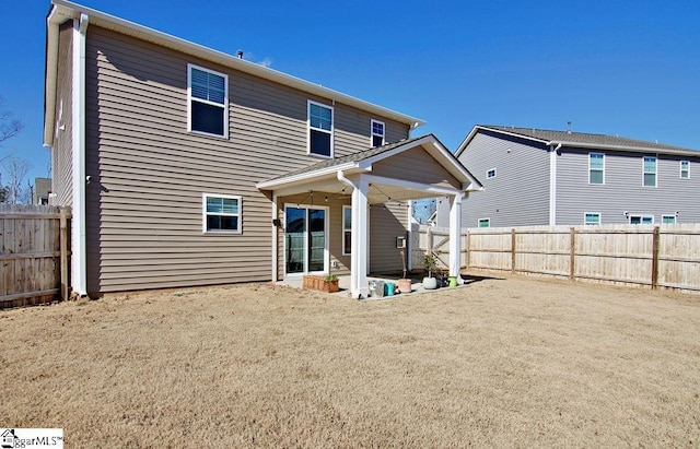 rear view of property with a lawn