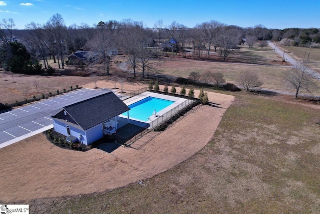 view of pool featuring a lawn