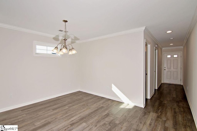 empty room with ornamental molding, dark hardwood / wood-style floors, and a chandelier