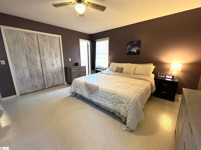 bedroom with a textured ceiling, a closet, and ceiling fan