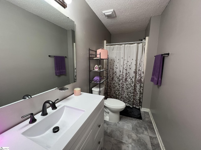 bathroom with vanity, toilet, a shower with shower curtain, and a textured ceiling