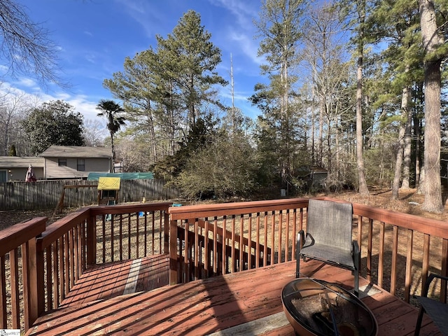 wooden terrace featuring an outdoor fire pit