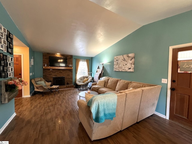 living room with dark hardwood / wood-style flooring, a fireplace, and vaulted ceiling