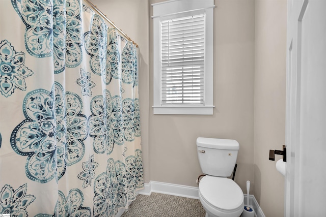 bathroom featuring toilet and tile patterned flooring