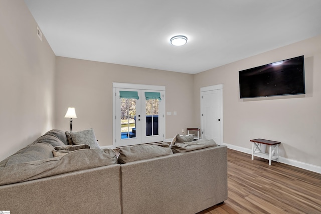 living room with hardwood / wood-style flooring and french doors