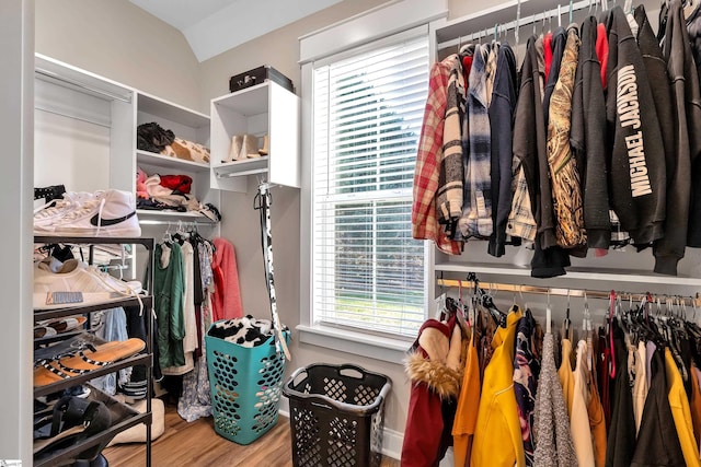 spacious closet featuring lofted ceiling and hardwood / wood-style flooring