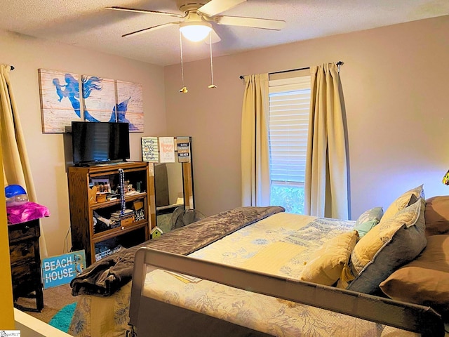 bedroom with a textured ceiling and ceiling fan