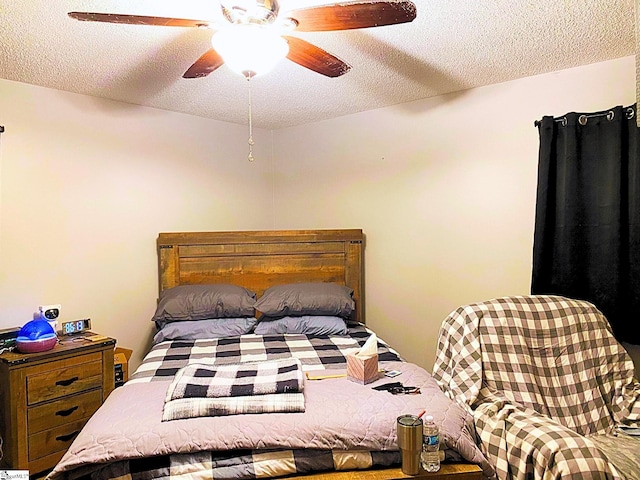 bedroom with a textured ceiling and ceiling fan