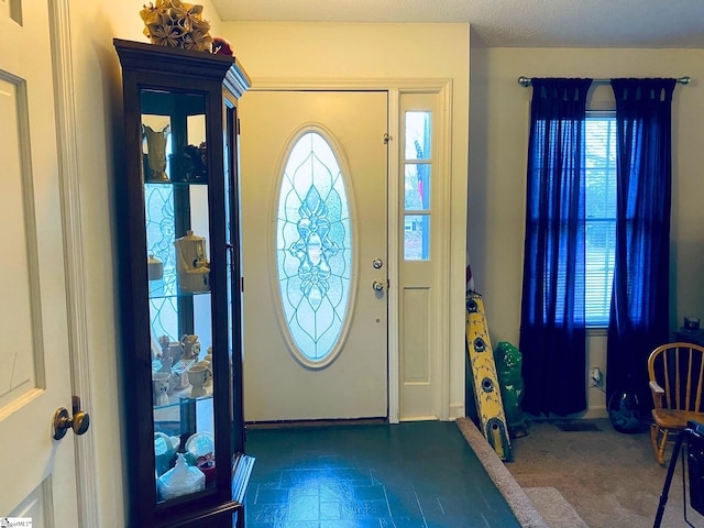 foyer entrance featuring a textured ceiling