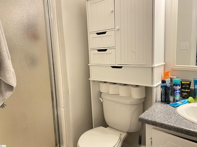 bathroom with vanity, toilet, and walk in shower