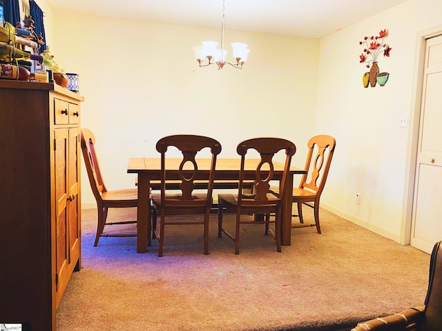 carpeted dining area featuring an inviting chandelier