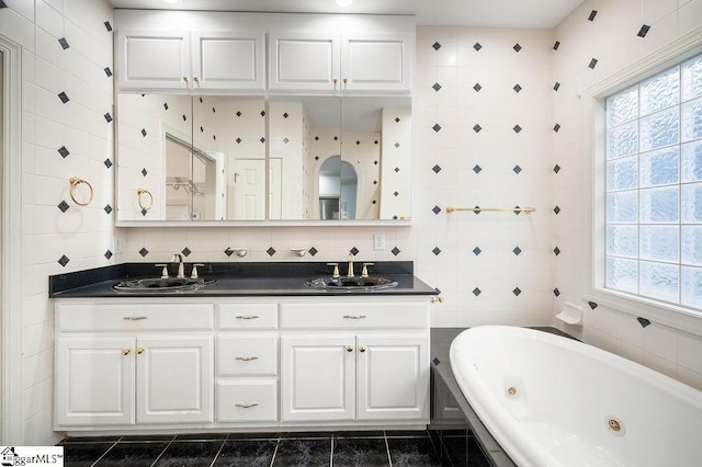 bathroom featuring tile walls, vanity, tile patterned floors, and a healthy amount of sunlight