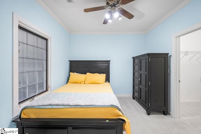 bedroom with crown molding, light colored carpet, and ceiling fan