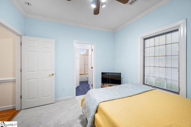 bedroom featuring carpet, ornamental molding, ceiling fan, and ensuite bathroom