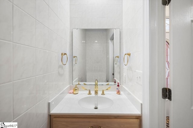 bathroom featuring vanity and tile walls