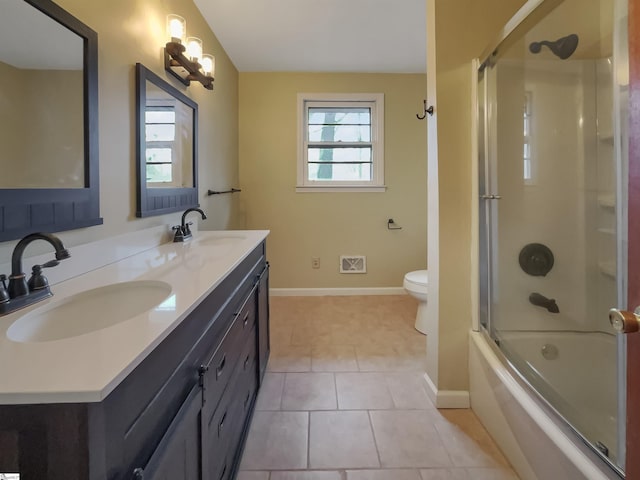 full bathroom with enclosed tub / shower combo, vanity, toilet, and tile patterned flooring