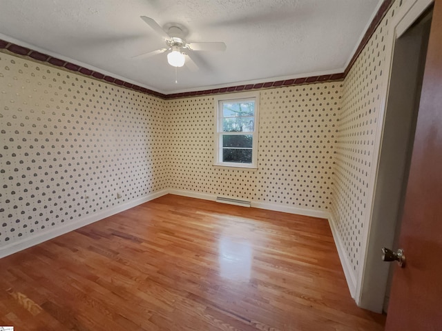 unfurnished bedroom featuring crown molding, a textured ceiling, ceiling fan, and light wood-type flooring