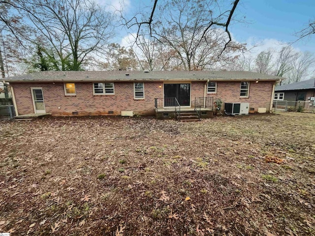 back of property featuring central AC