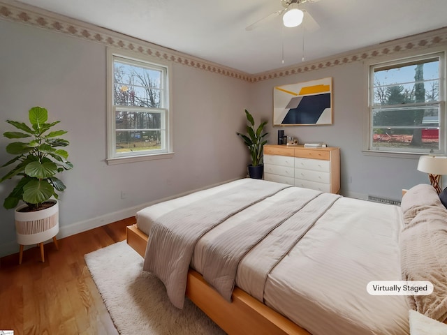 bedroom with hardwood / wood-style flooring and ceiling fan