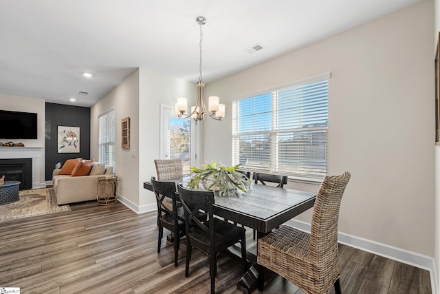 dining area featuring hardwood / wood-style flooring and a notable chandelier