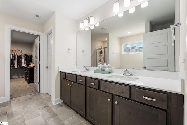 bathroom with a shower with door and vanity