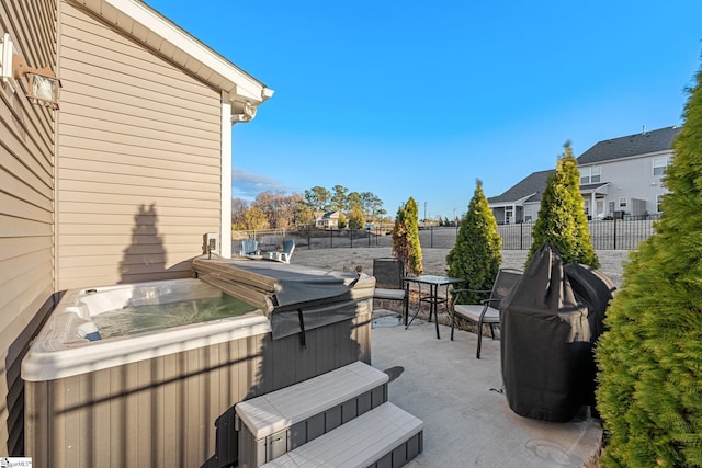 view of patio / terrace with a hot tub