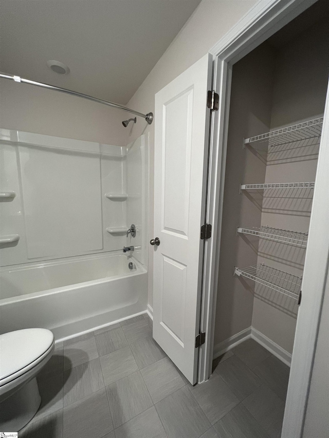 bathroom with shower / washtub combination and toilet