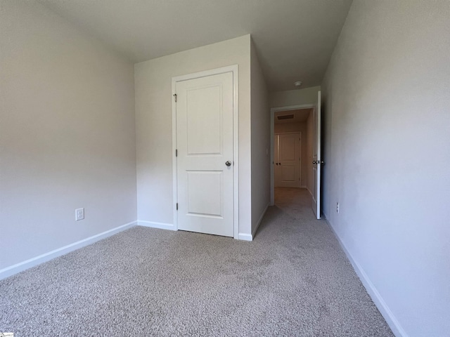 unfurnished bedroom with light carpet