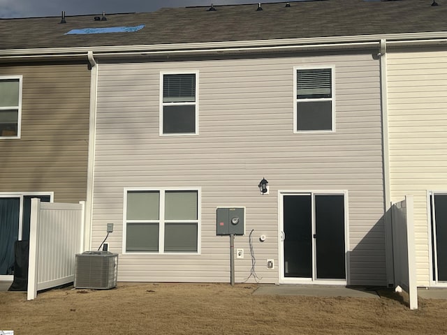 rear view of house featuring central air condition unit