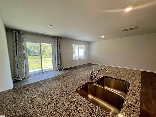 kitchen featuring sink, plenty of natural light, and dark stone counters