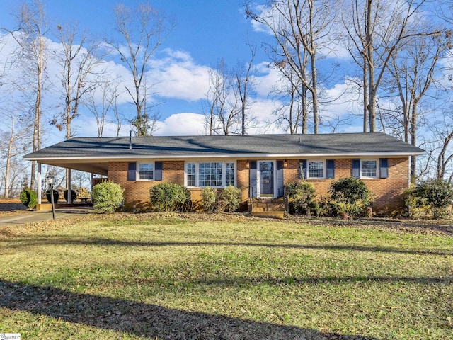 ranch-style house featuring a carport and a front lawn