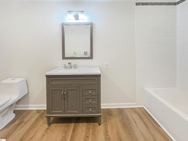 bathroom featuring vanity, hardwood / wood-style flooring, and toilet