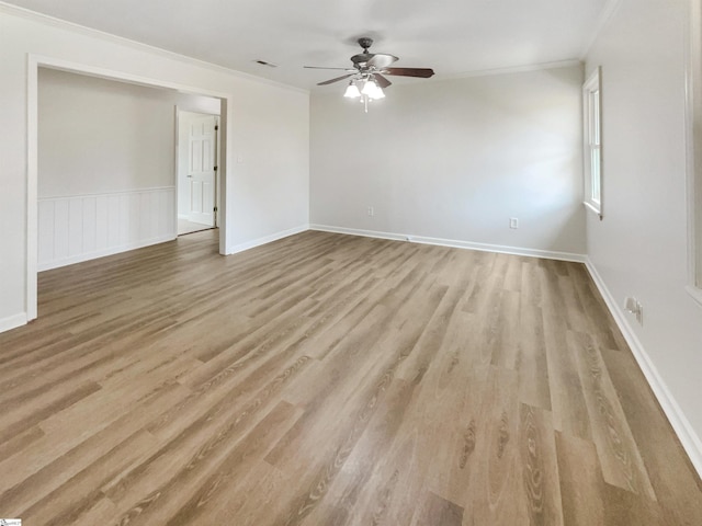 empty room with crown molding, ceiling fan, and light wood-type flooring