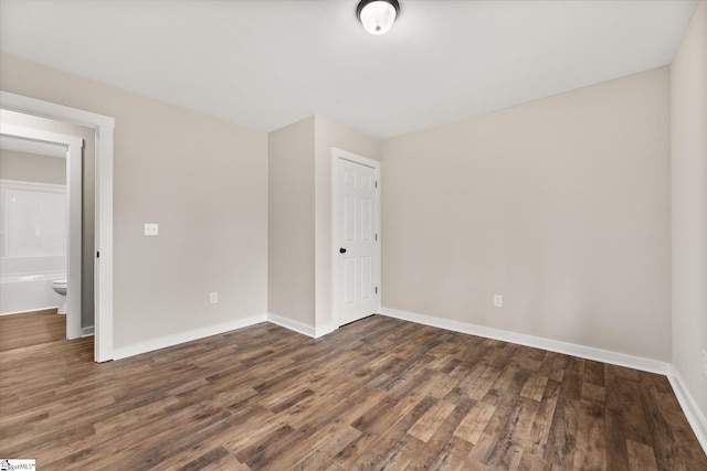 empty room with dark wood-type flooring