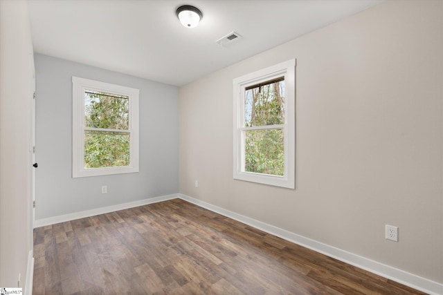 empty room featuring dark hardwood / wood-style floors