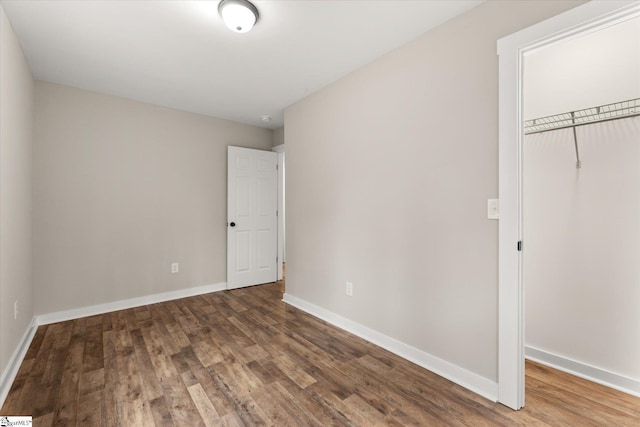 unfurnished bedroom featuring hardwood / wood-style flooring and a closet