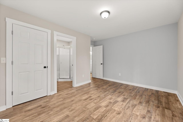 unfurnished bedroom featuring light hardwood / wood-style flooring and a closet