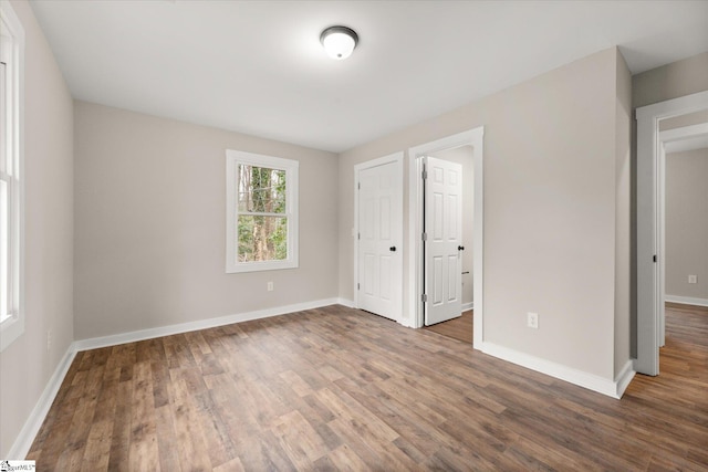 unfurnished bedroom with dark hardwood / wood-style floors