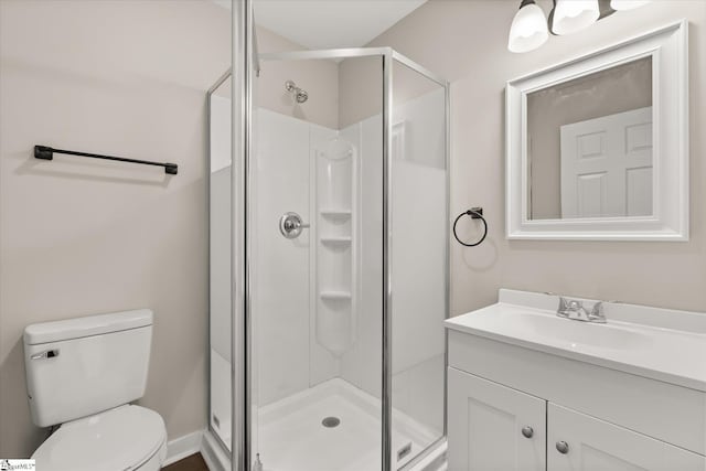 bathroom with vanity, toilet, and an enclosed shower